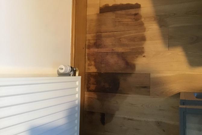 Badly stained oak floor caused by water damage fully restored